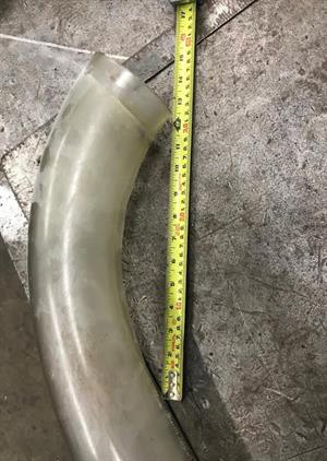 A used bend needing to be replaced next to a metal ruler