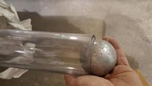 Placing a machined metal ball inside of a tube to test its ovality