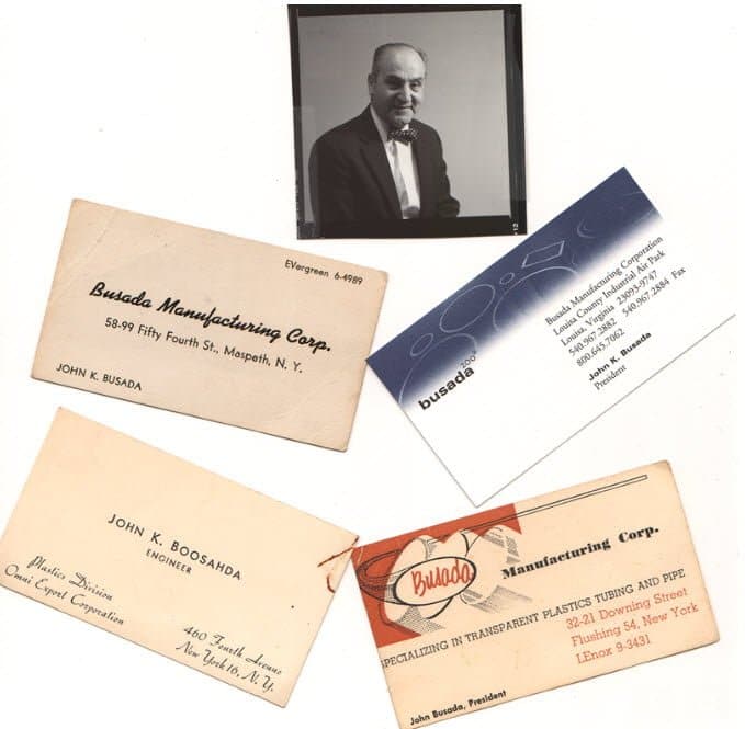 A collection of John Busada's business cards through the years