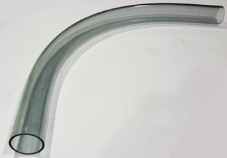 A clear butyrate tubing bend on a white background