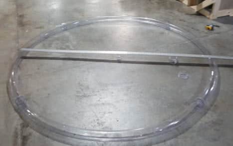 A finished circle bend made of butyrate tubing on the fabrication shop floor.
