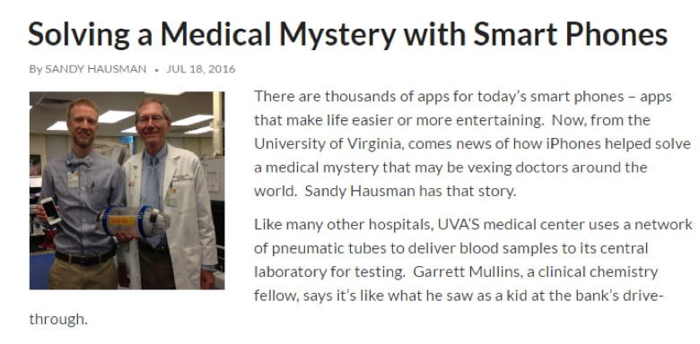 Screenshot of a news article. An image shows two hospital doctors holding a phone and a pneumatic carrier. Text says, "There are thousands of apps for today's smart phones - apps that make life easier or more entertaining. Now, from the University of Virginia, comes news of how iPhones helped solve a medical mystery that may be vexing doctors around the world. Sandy Hausman has that story. Like many other hospitals, UVA's medical center uses a network of pneumatic tubes to deliver blood samples to its central laboratory for testing. Garrett Mullins, a clinical chemistry fellow, says it's like what he saw as a kid at the bank's drive through."