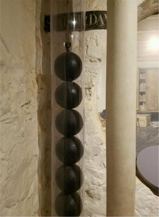 The display tube protecting the cannonball clock weights installed in Monticello.