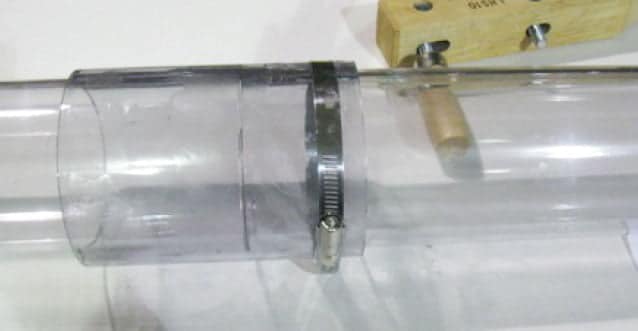 Two pieces of transparent butyrate tubing with a sleeve connector attached