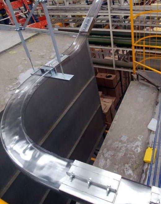 A rectangular pneumatic tubing system over a warehouse area