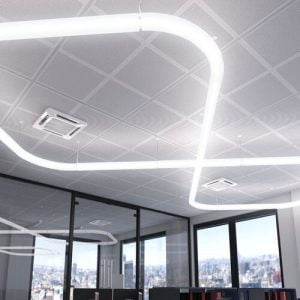 A zig zag shaped light fixture covering an office ceiling
