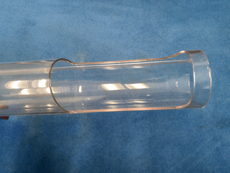 A section of clear tubing with a cutout.