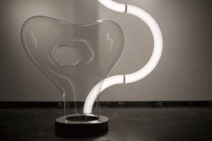 An artistic lighting display made with spectar stratus tubing and an abstract glass sculpture.