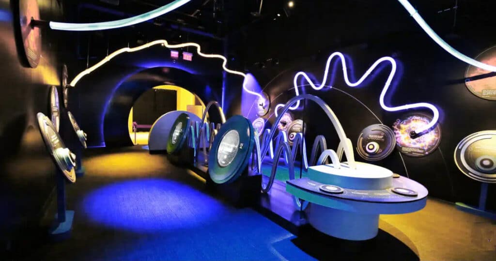 A museum exhibit using colored and illuminated Spectar Stratus tubing formed into bends and long curves.